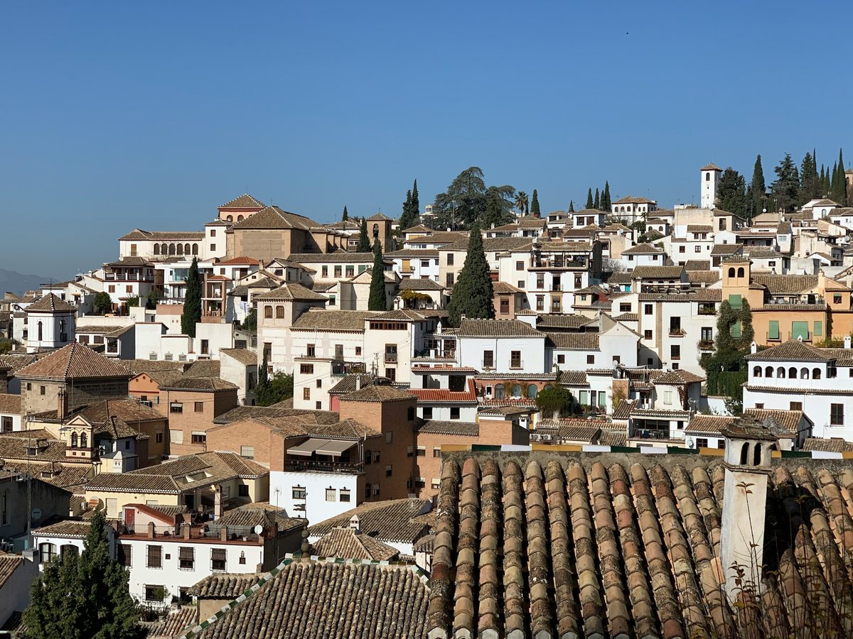 The Albaicín in Granada, a historic hillside neighbourhood of whitewashed houses, traditional tiled roofs and narrow streets