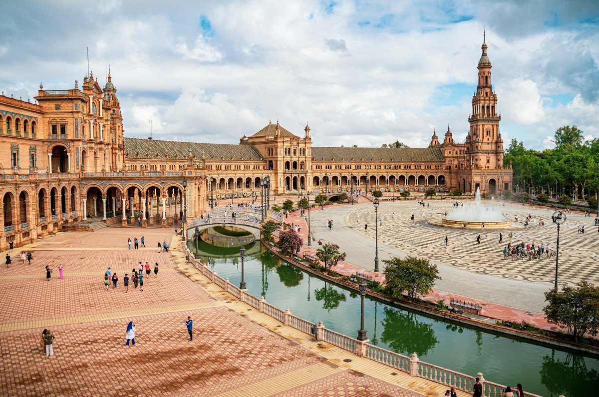 Plaza de España in Seville, featuring its grand Neo-Mudéjar architecture, tiled bridges, canal and central fountain
