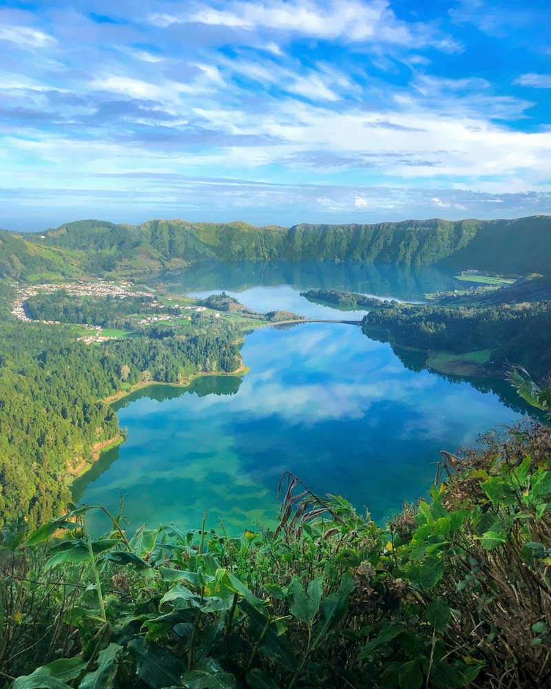 Twin crater lakes of Sete Cidades surrounded by lush green caldera walls on São Miguel