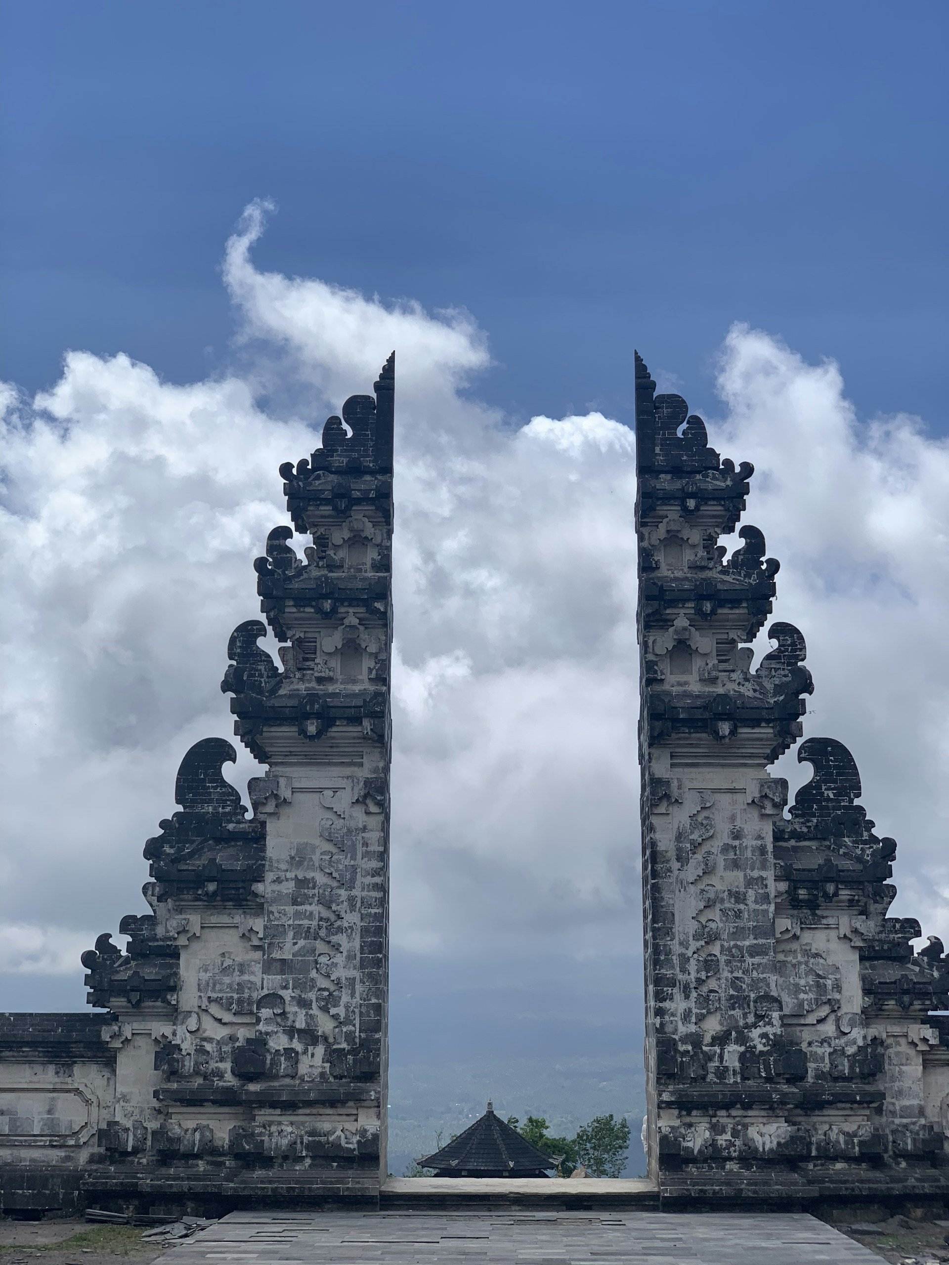 Balinese Hindu temple gateway under a clear blue sky in Karangasem, Bali