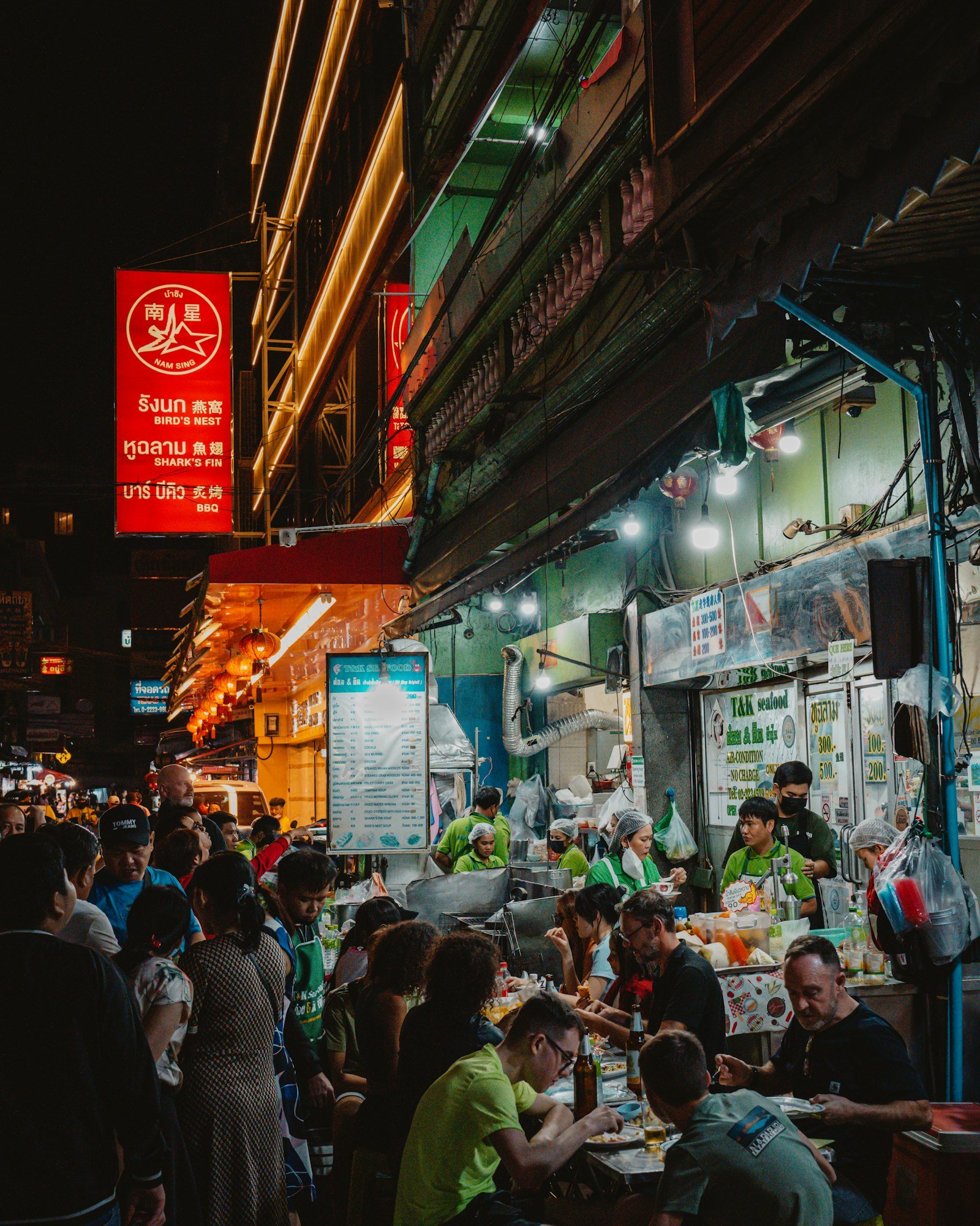 People dining at outdoor restaurant tables in Thailand