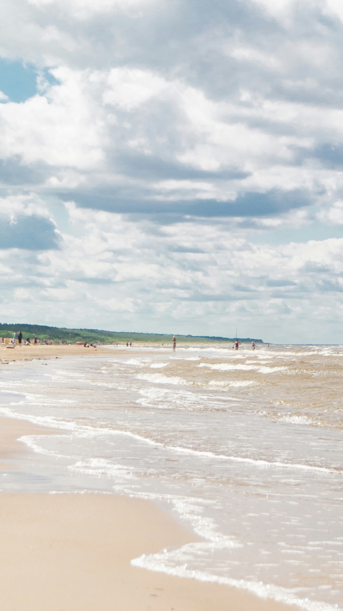 People on the sandy shores of Jūrmala Beach