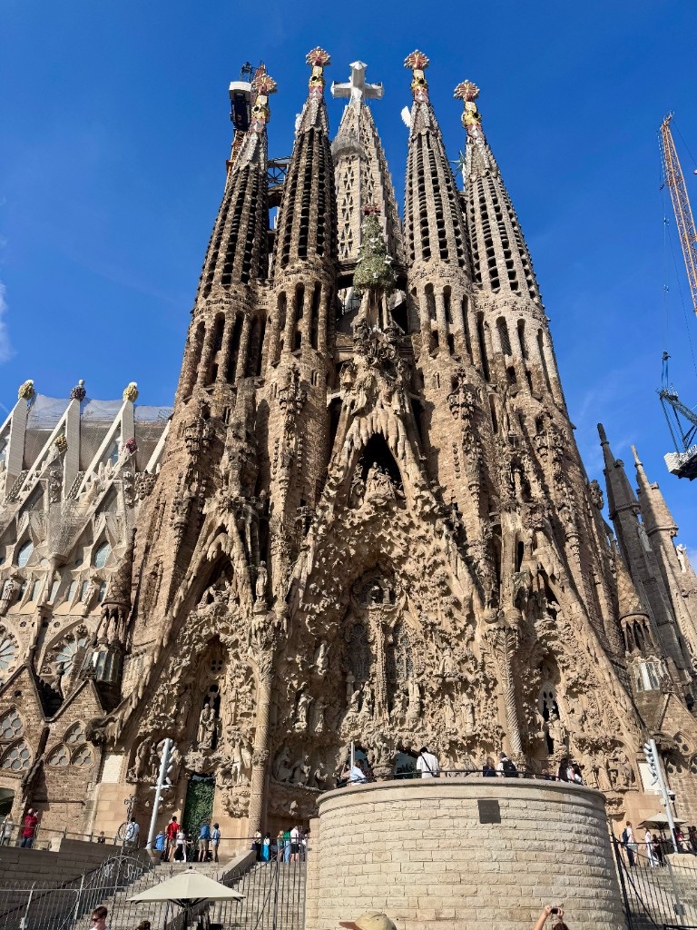 Nativity Facade of the Sagrada Família with its ornate stone carvings and towers rising against a clear blue sky