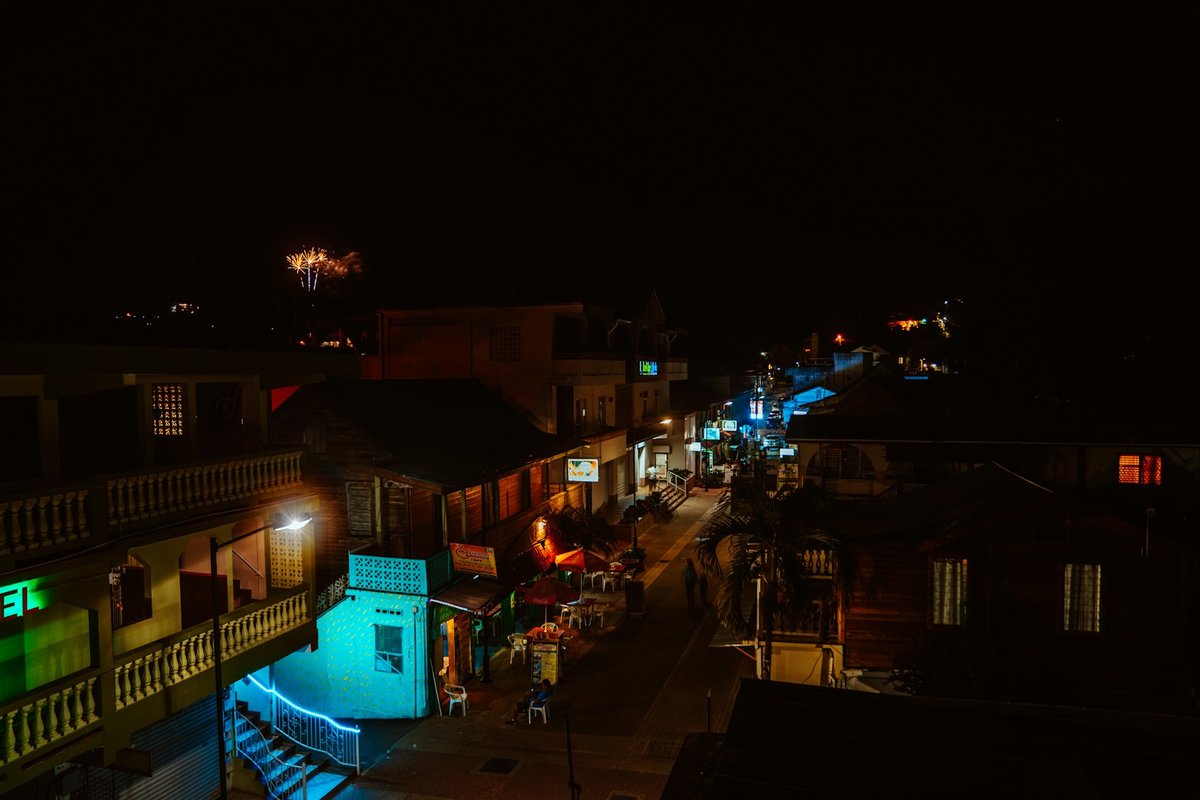 San Ignacio at night, with colourful lights on streets, small shops, restaurants and local businesses in the downtown area