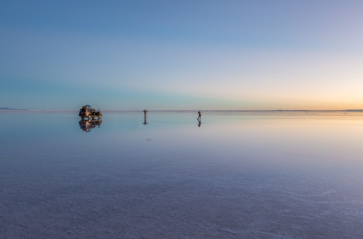 4x4 and reflections on Salar de Uyuni at sunrise