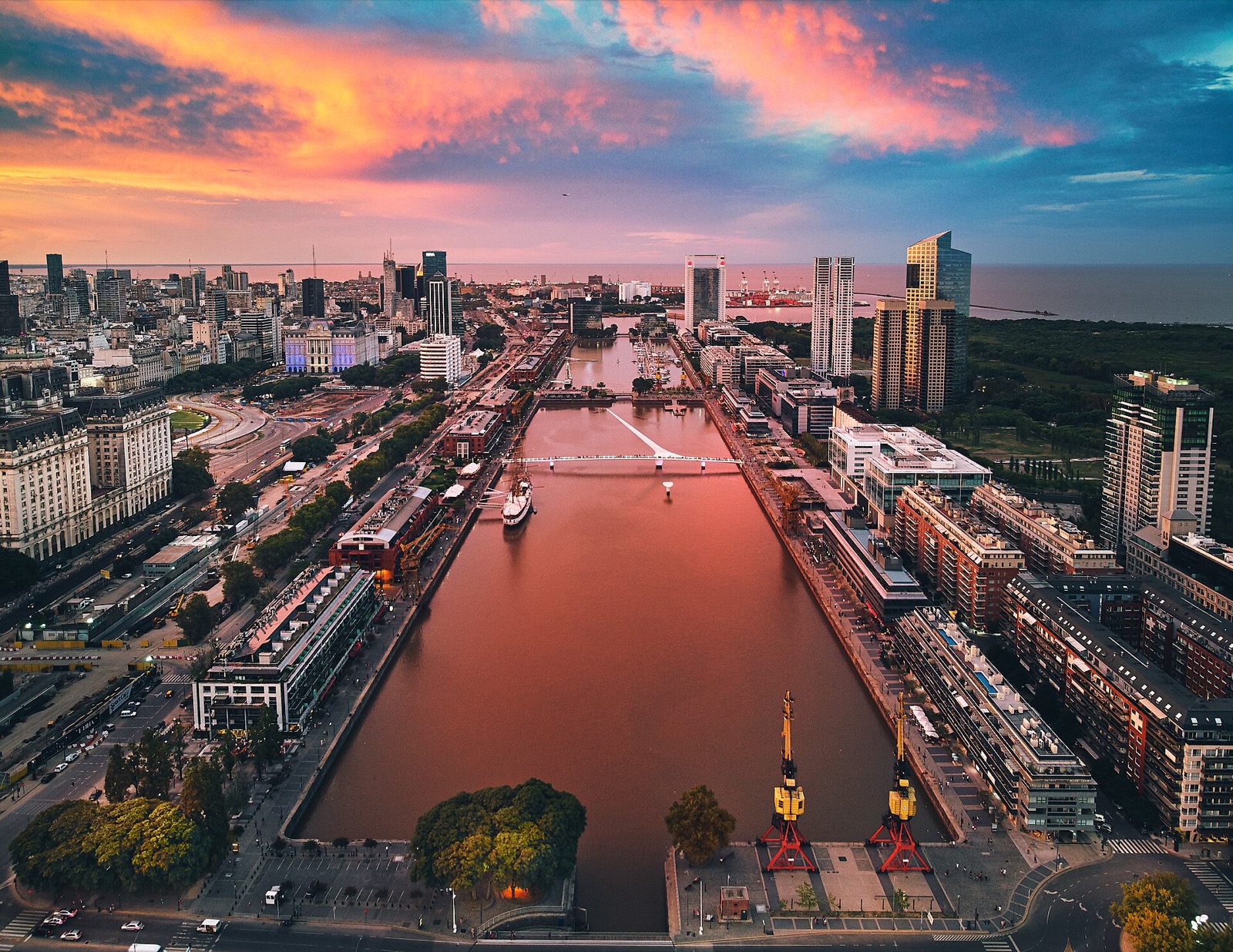 Evening aerial view of Puerto Madero in Buenos Aires with the waterfront canal and Puente de la Mujer