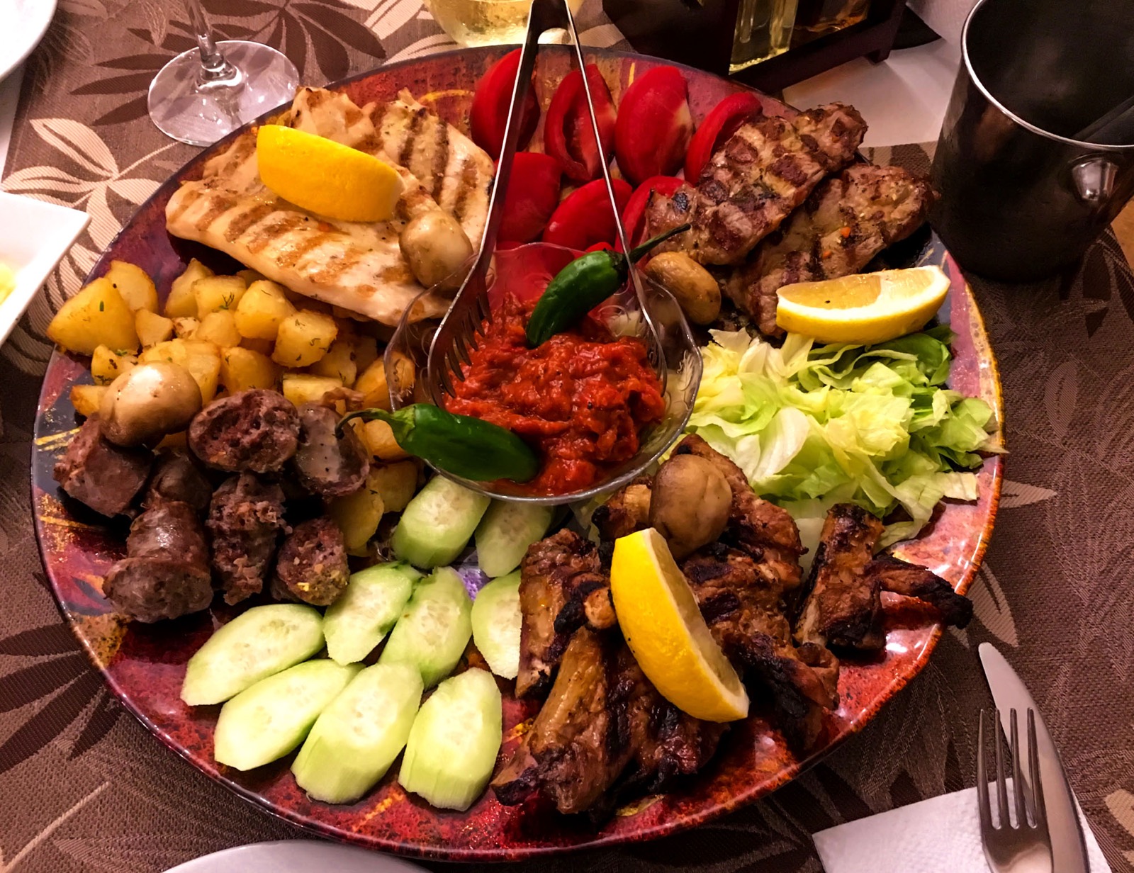 Bulgarian platter with grilled meat, garnish and lyutenitsa sauce