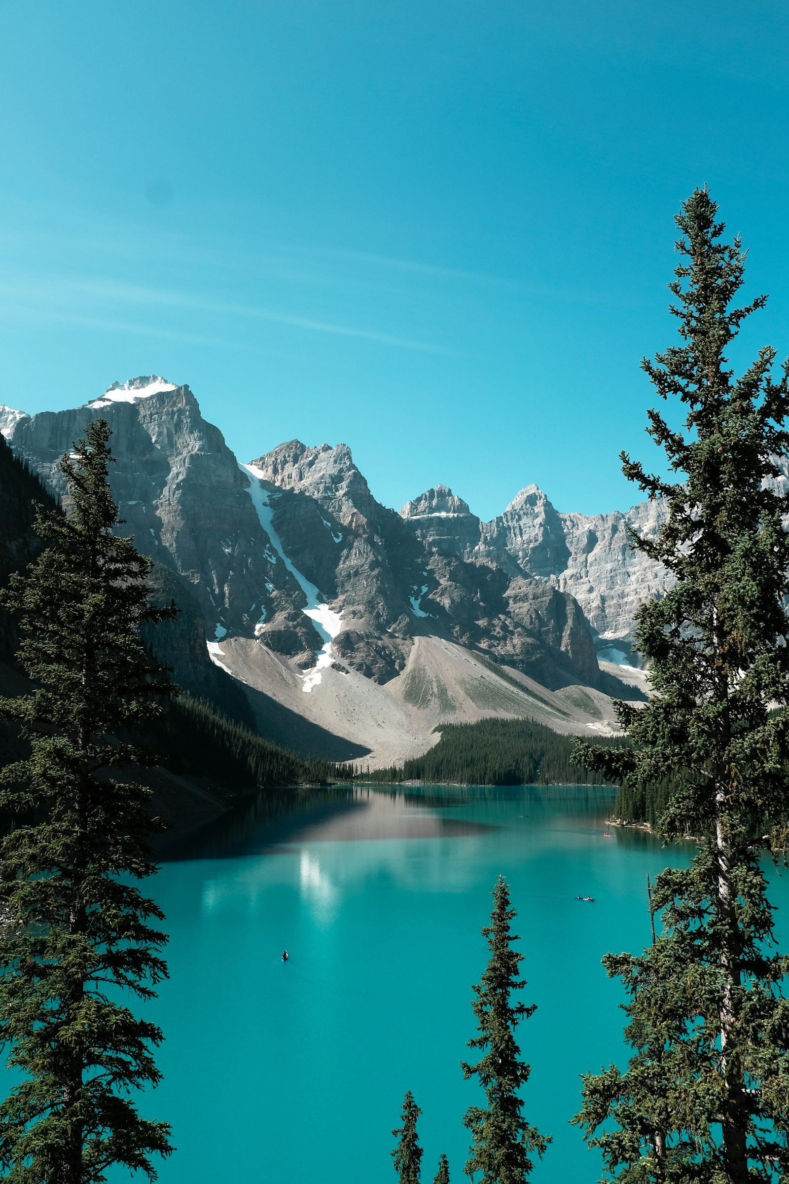 Mountain lake landscape in Banff National Park with dramatic peaks reflected in calm water