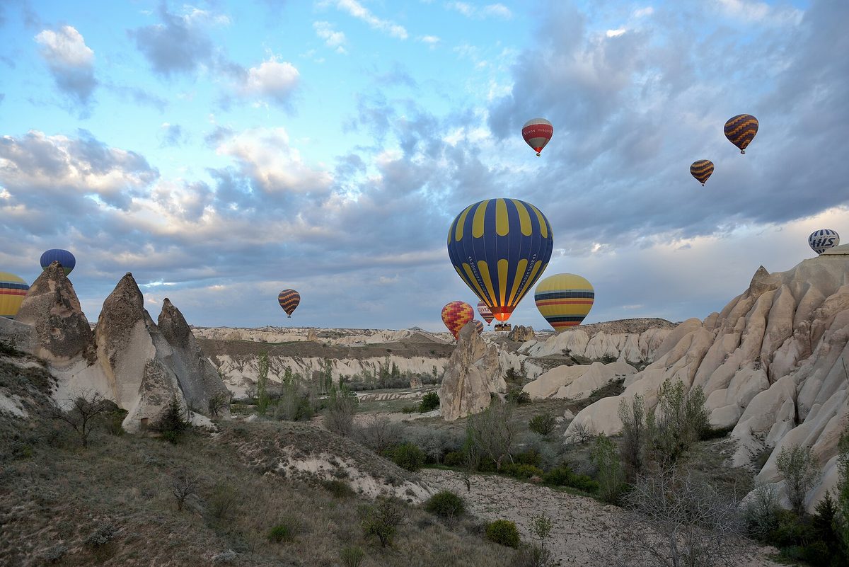 Hot air balloons rising over Cappadocia at sunrise