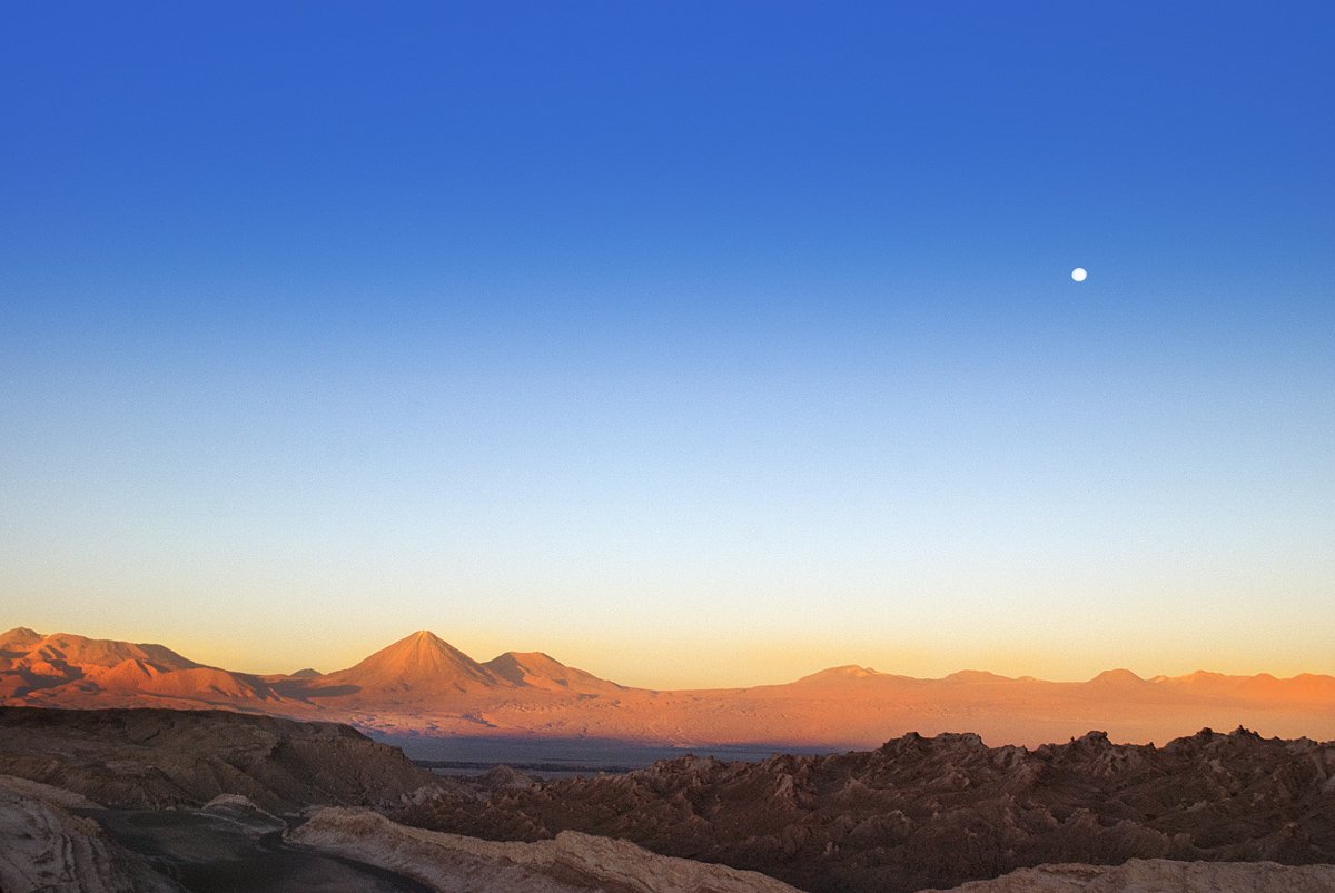 Eroded salt-and-rock formations of Valley of the Moon stretching across barren desert under a blue sky