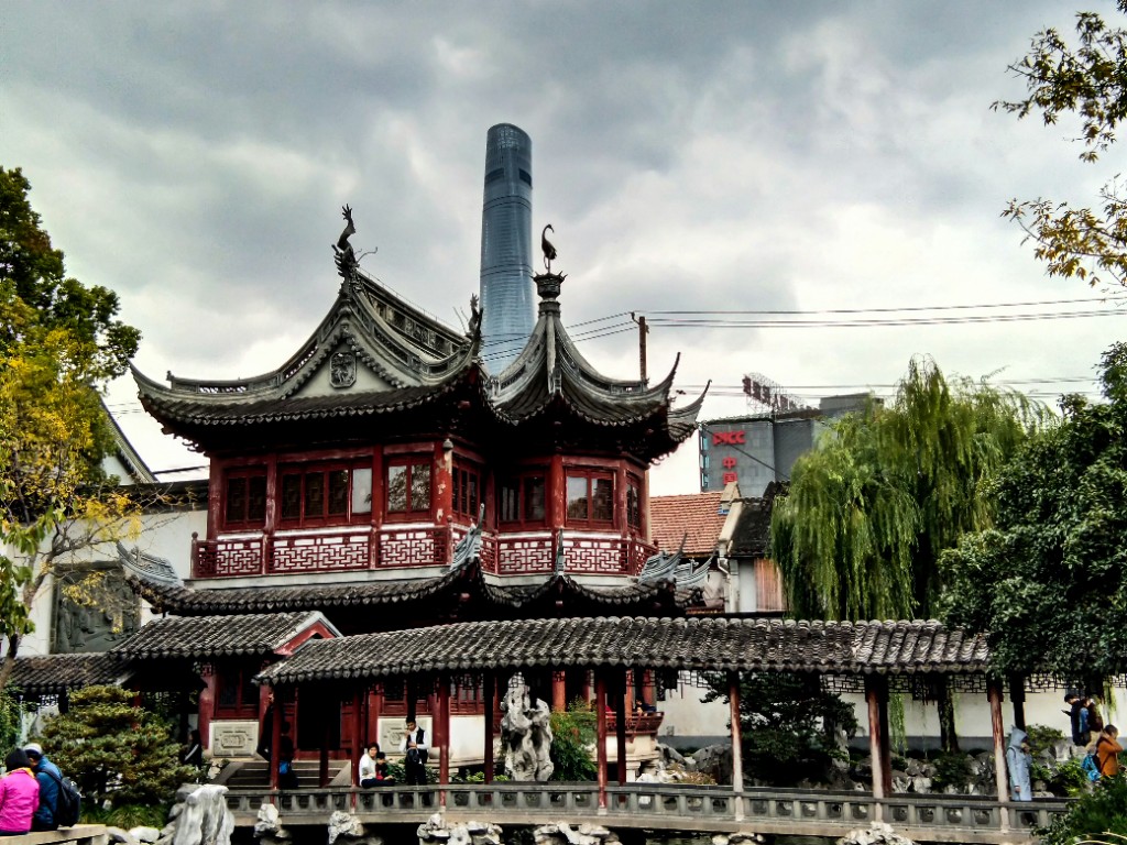 Traditional Chinese pavilion near Yu Garden with Shanghai Tower rising behind it