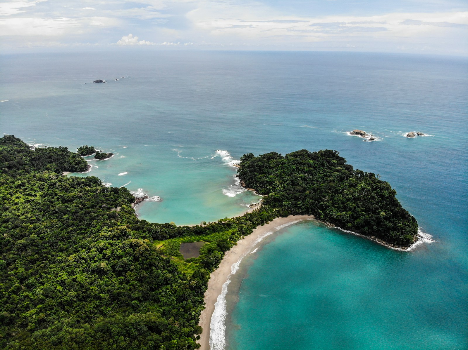 Green trees beside the blue Pacific at Manuel Antonio Beach, Costa Rica