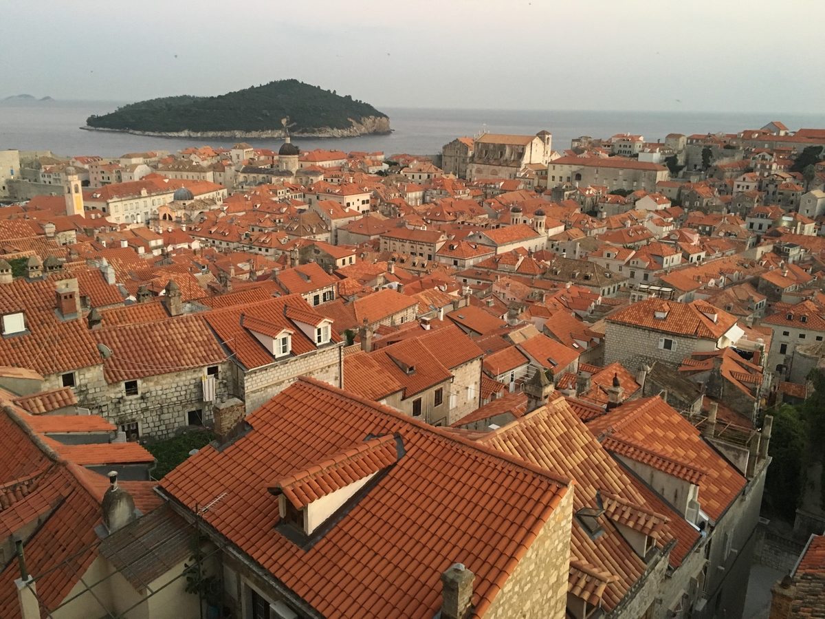 Coastal old town in Croatia with stone buildings and blue Adriatic water