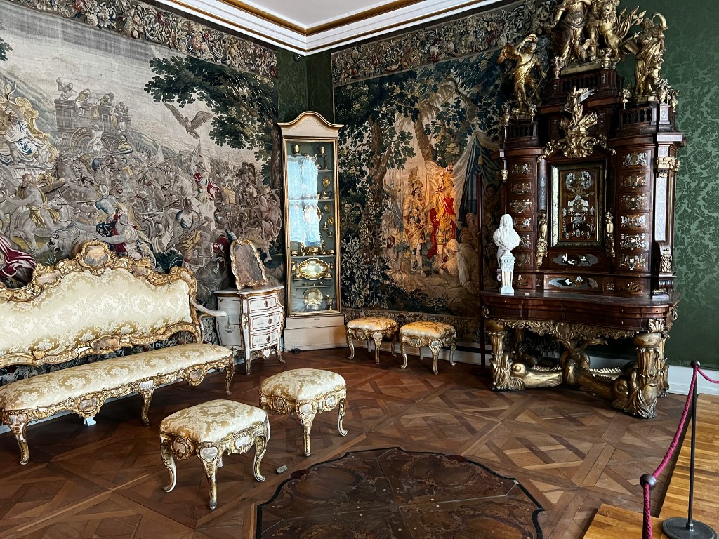 Ornate state room with tapestries and gilded furniture inside Rosenborg Castle, Copenhagen