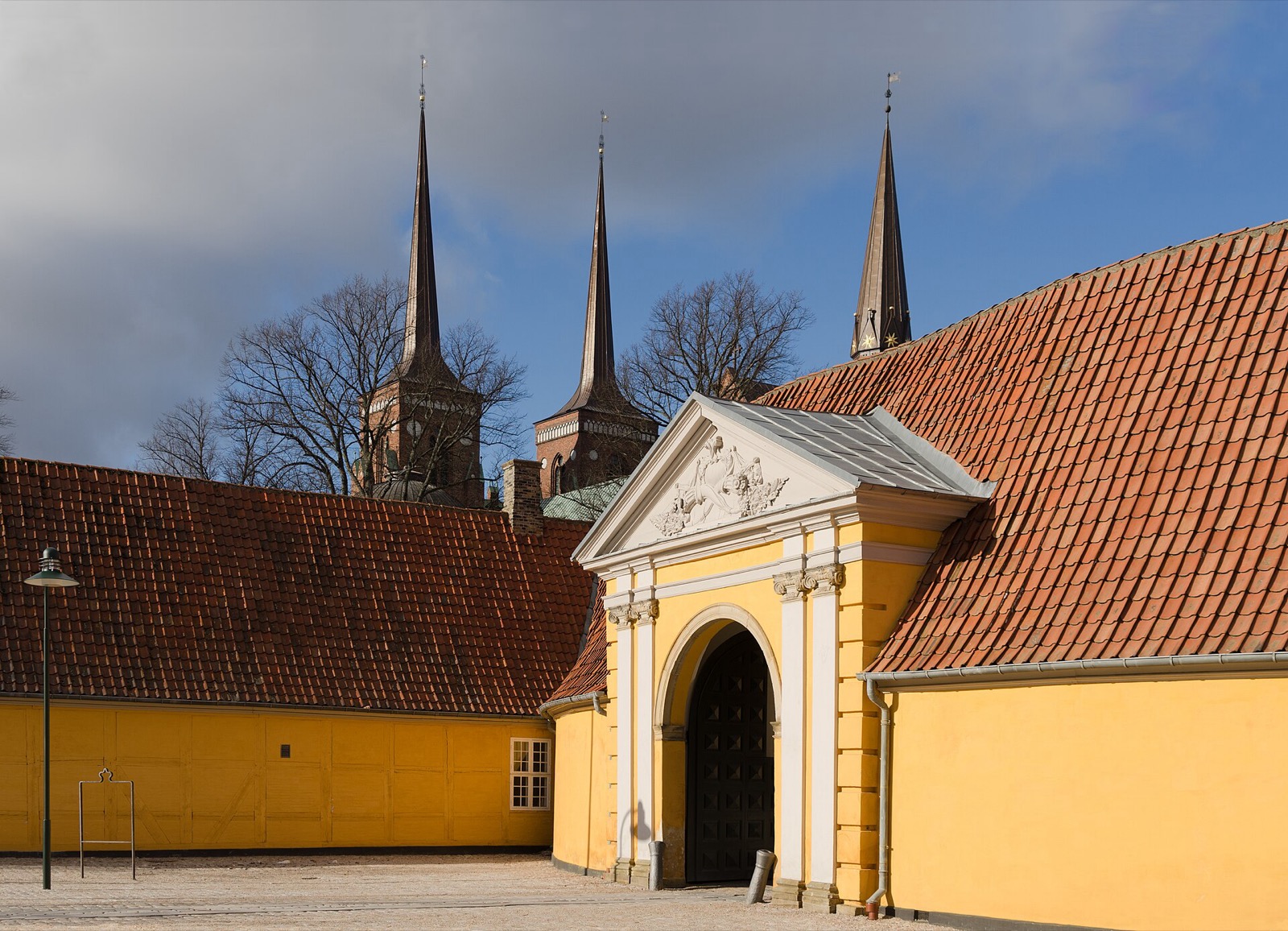 Twin spires of Roskilde Cathedral above the palace towers