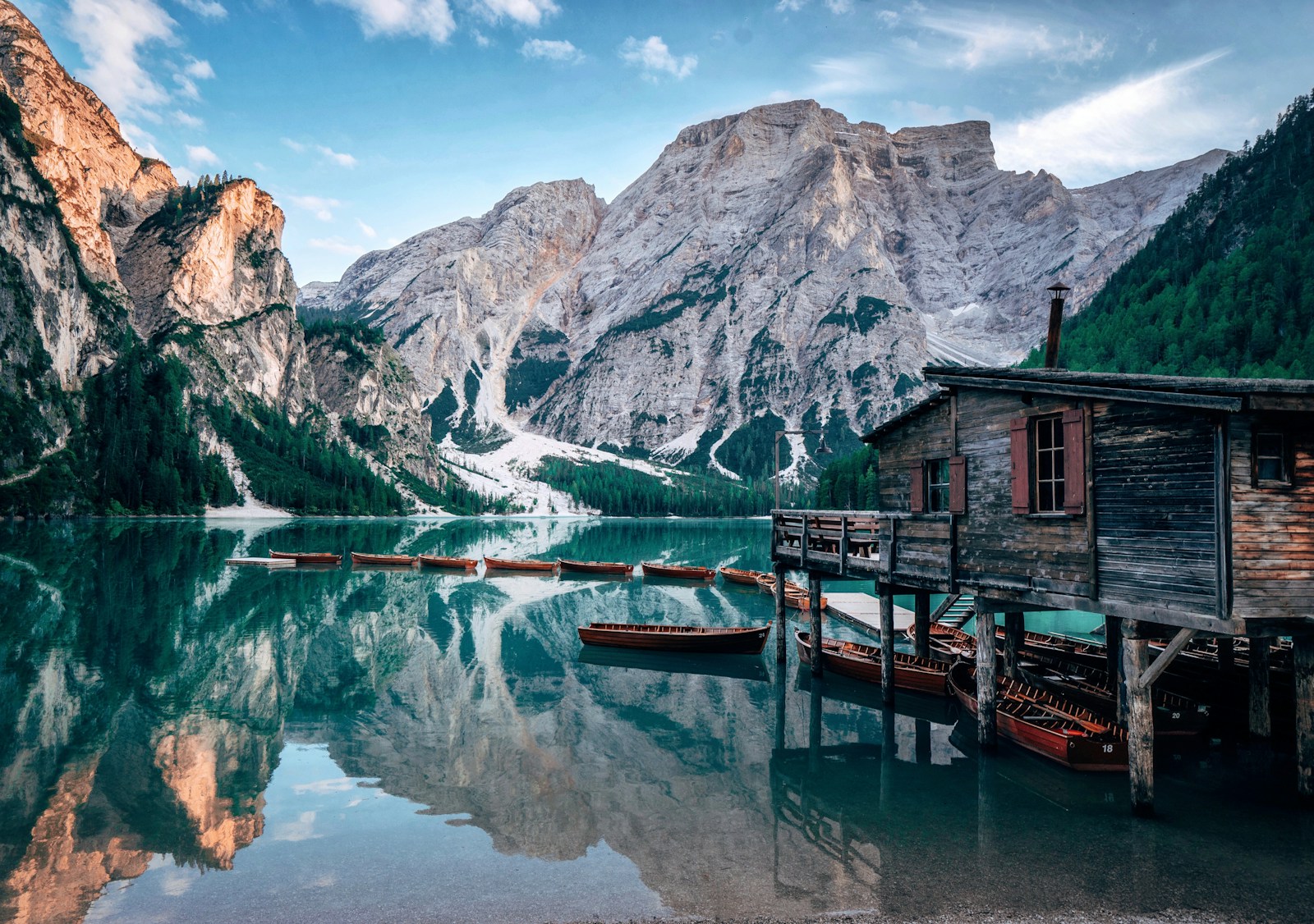 Lago di Braies, also known as Pragser Wildsee, with a wooden cabin beside the alpine lake in the Dolomites