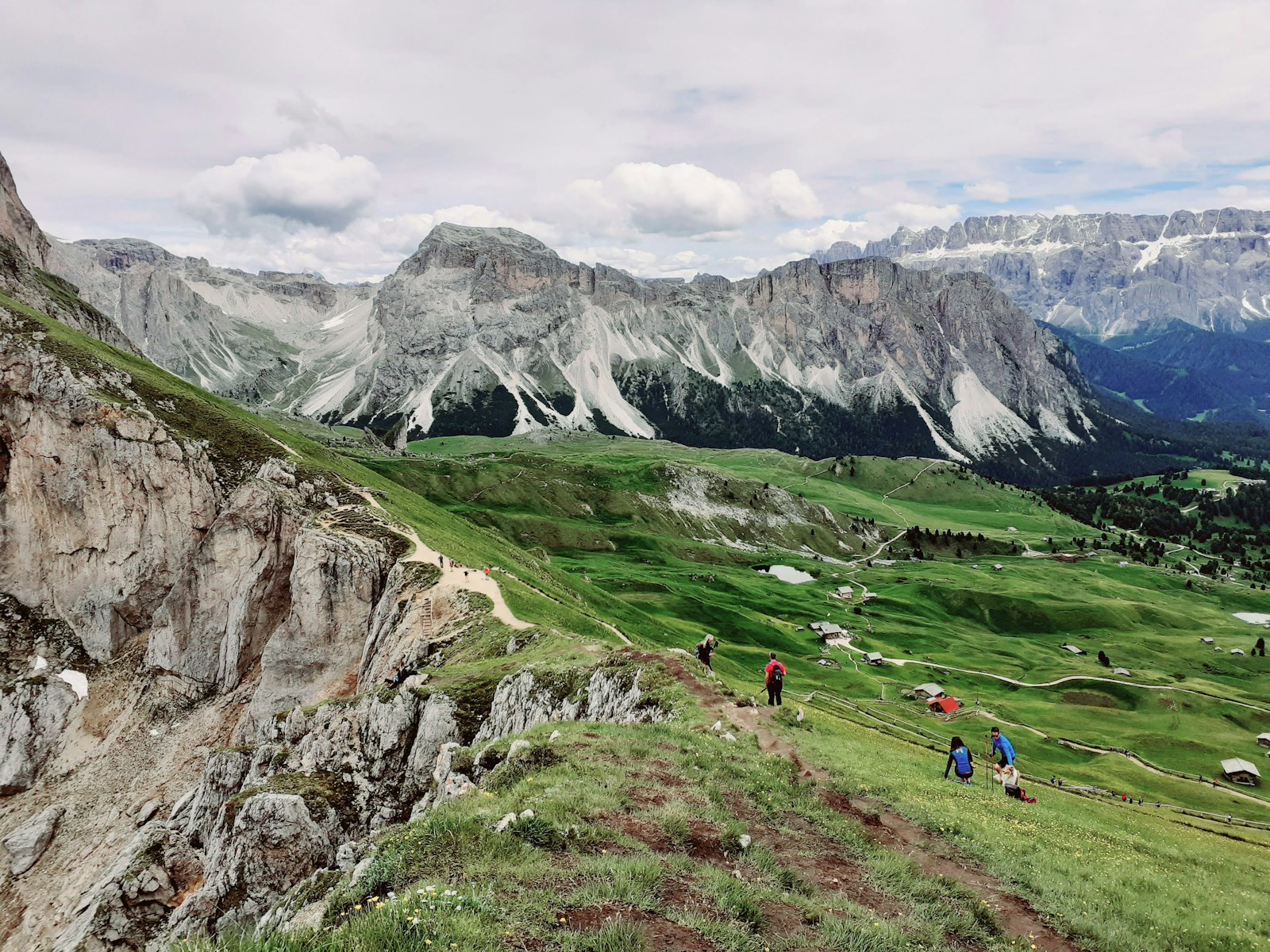 The Seceda ridgeline in the Dolomites with lush alpine meadows beneath dramatic rocky peaks