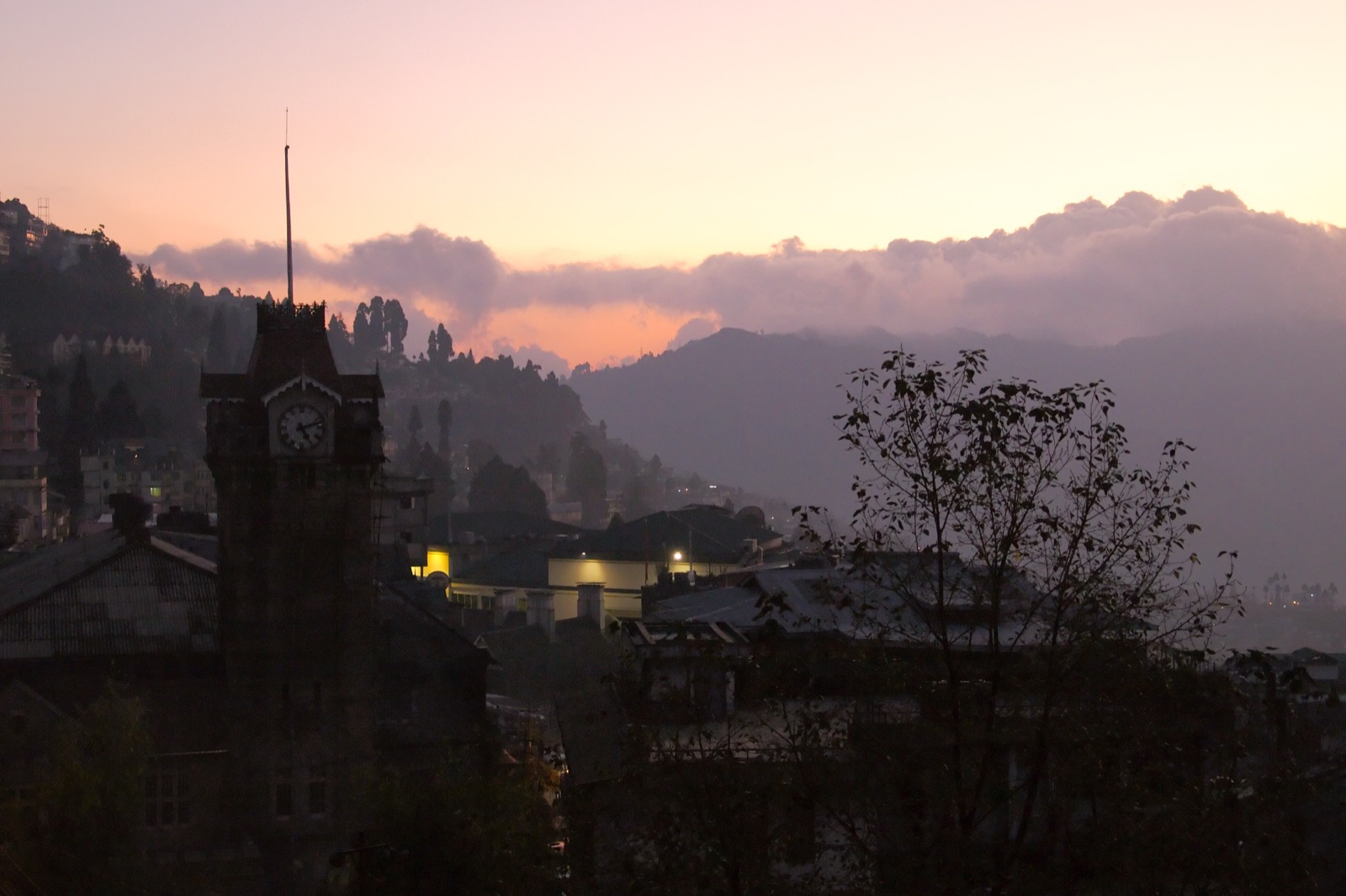 Darjeeling hill town wrapped in mist with mountain backdrop