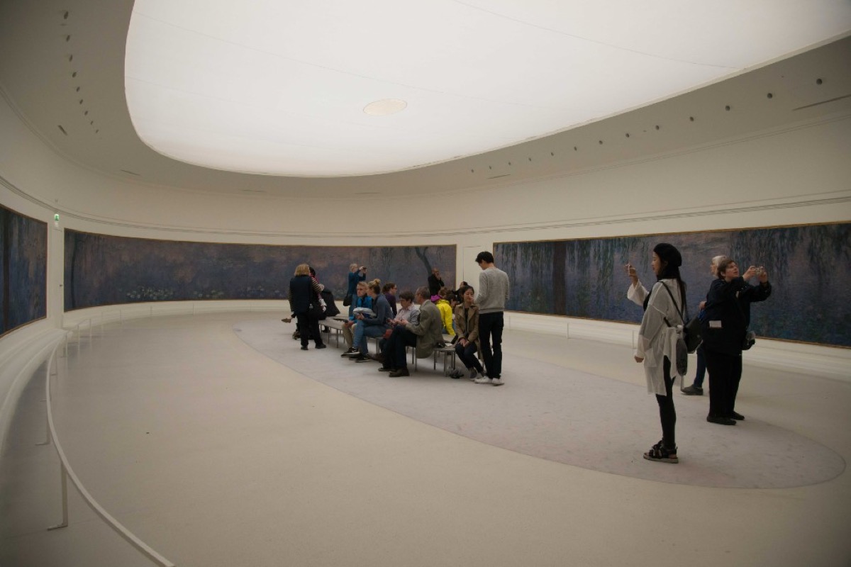 Monet's Water Lilies displayed in the oval gallery at Musee de l'Orangerie in Paris