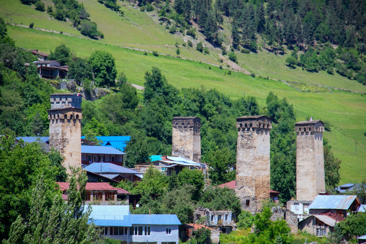 Medieval Svan towers in Mestia with mountains behind