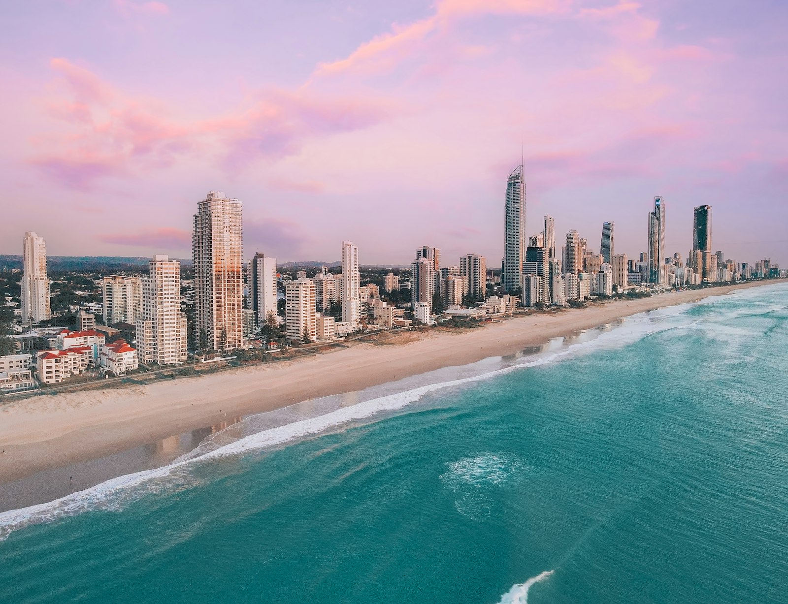Surfers Paradise beach, turquoise ocean, and Gold Coast skyline at sunrise