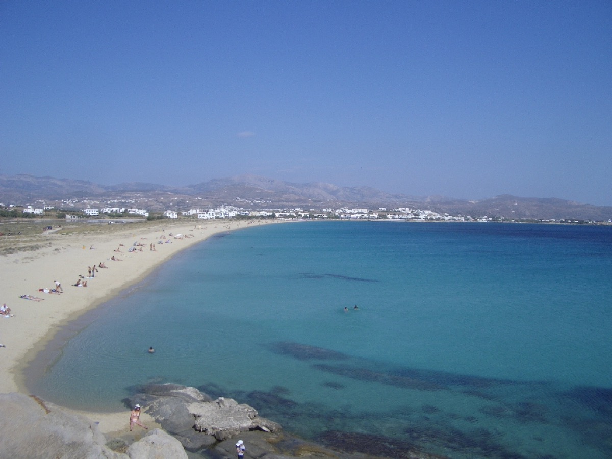 Long sandy beach and clear blue sea in Naxos