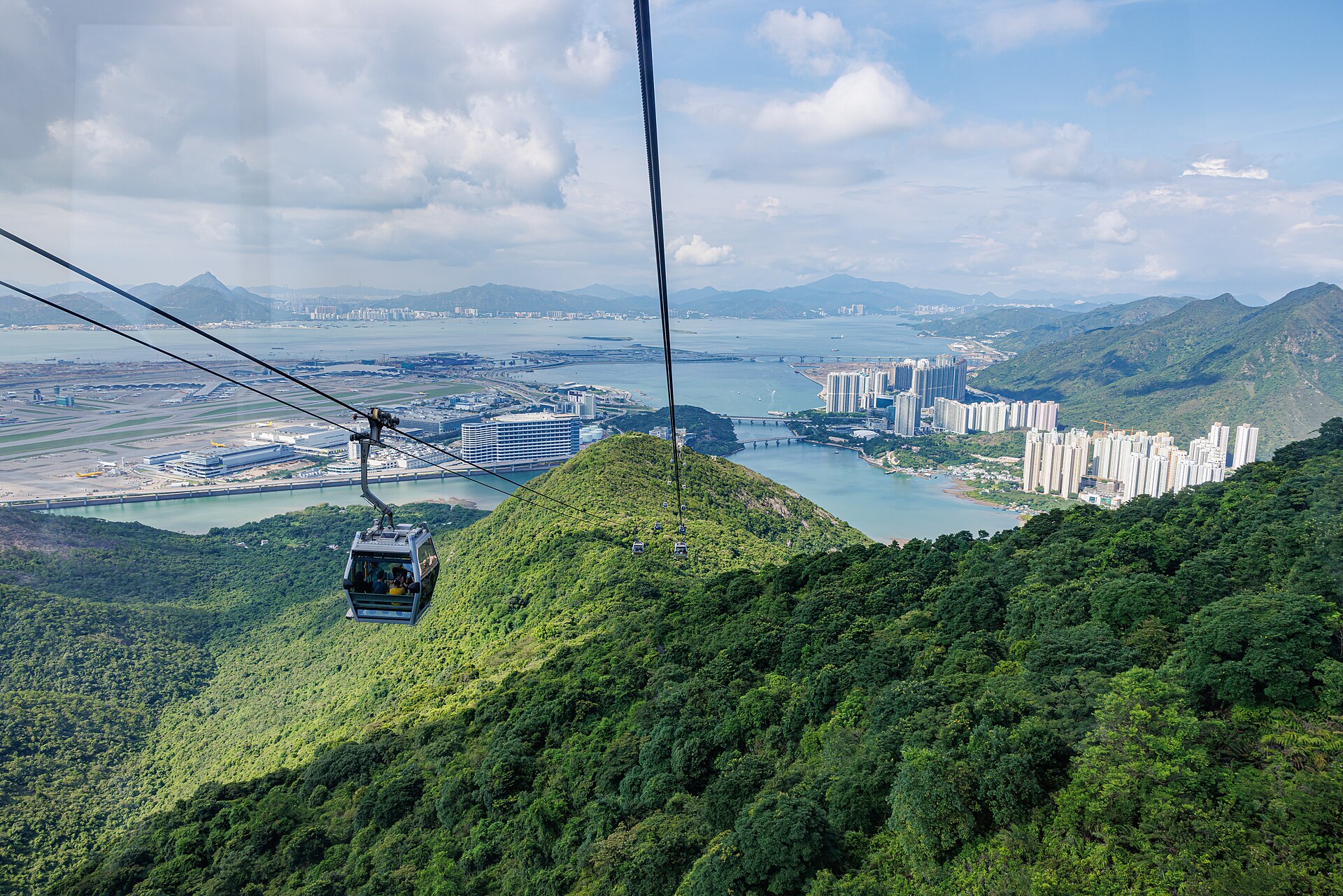 Ngong Ping 360 cable car crossing mountainous landscape on Lantau Island