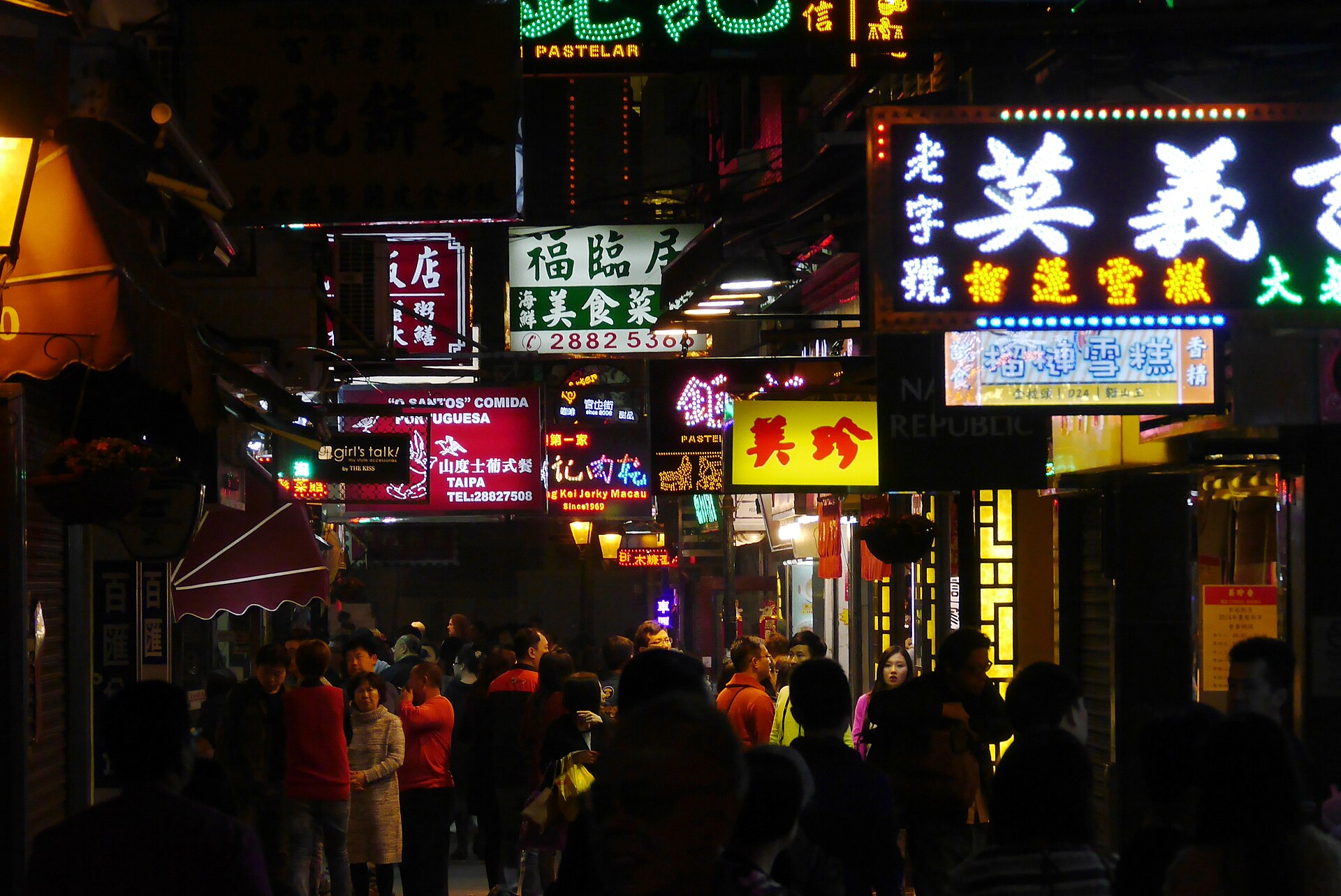 Rua do Cunha in Taipa Village, Macao, a narrow pedestrian street lined with shops and snack stalls