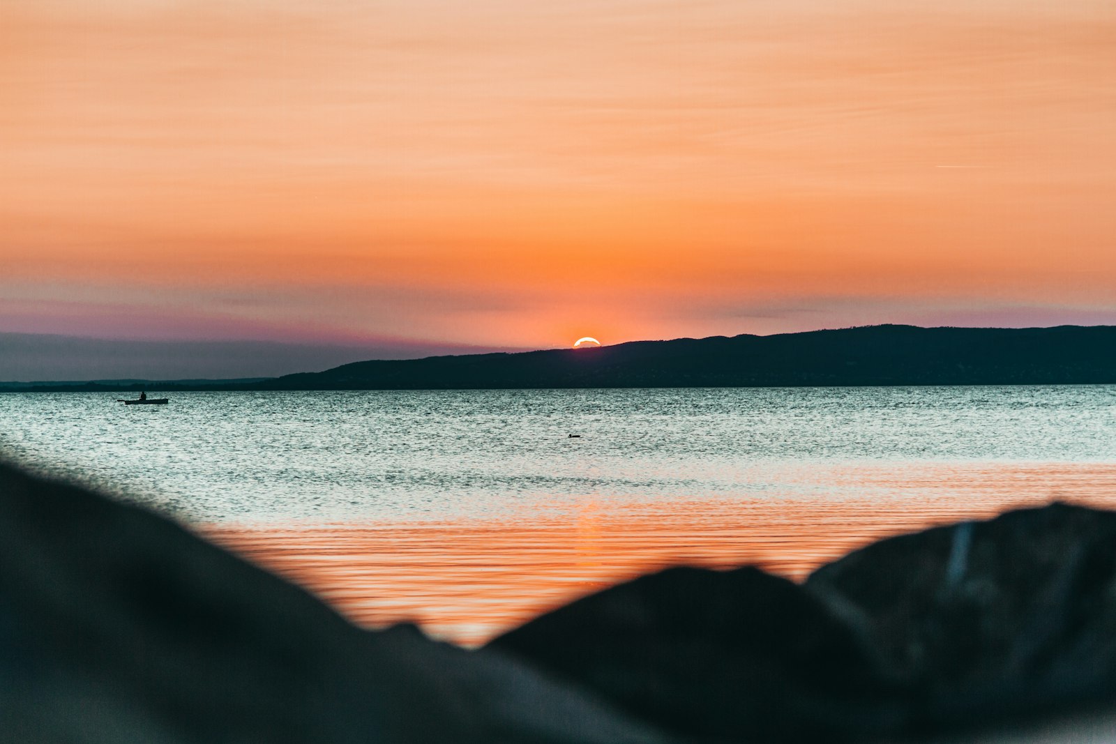 Lake Balaton shoreline under an orange sky