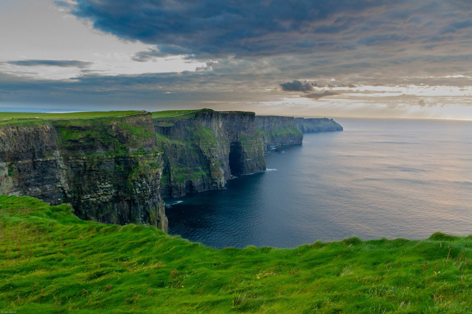 Green clifftop paths beside the Atlantic at the Cliffs of Moher