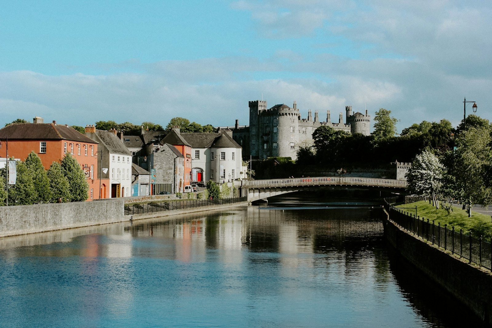 A river running through Kilkenny beside historic buildings