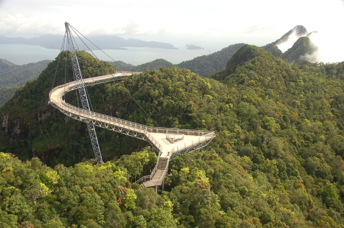 The curved Langkawi Sky Bridge suspended above rainforest-covered mountains