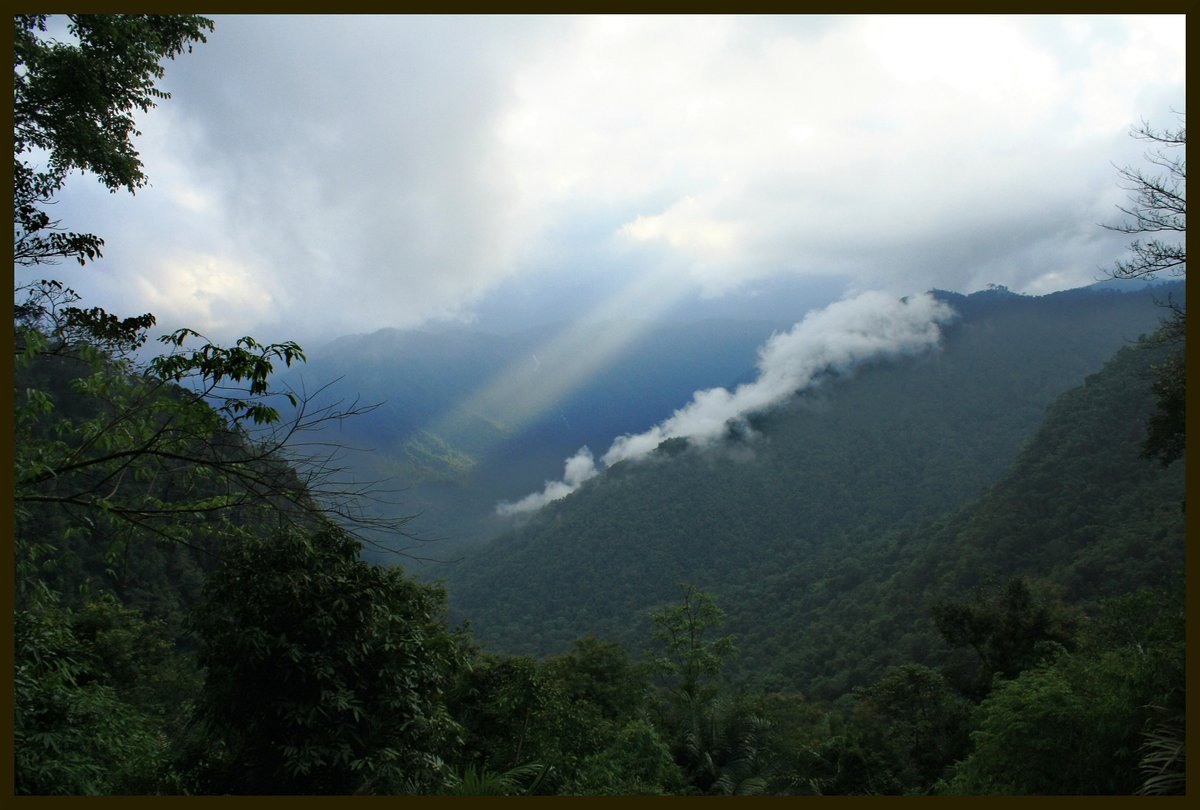 Sunbeams breaking through monsoon clouds over the Western Ghats in Kerala