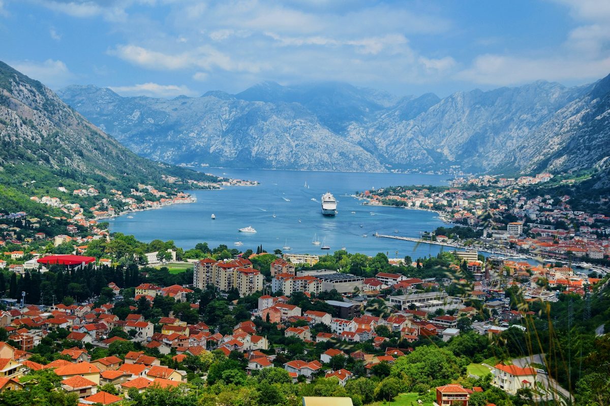 Aerial coastal view of Montenegro, with a town beside the Adriatic during daytime