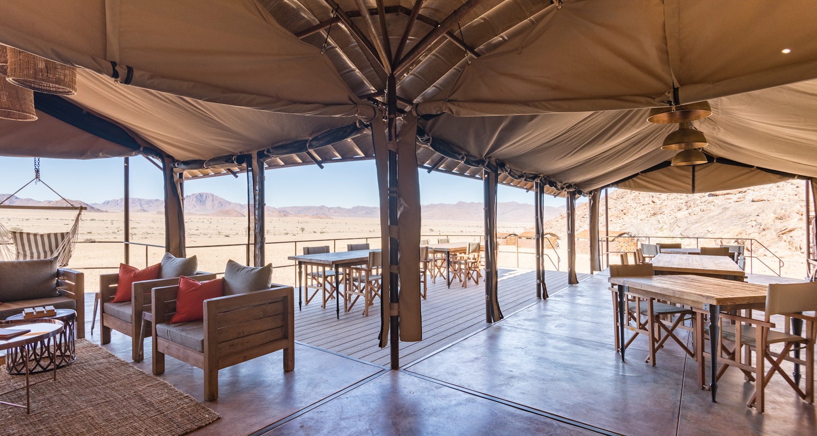 Open-sided desert lodge lounge and dining tent overlooking the Namib plains near Sesriem