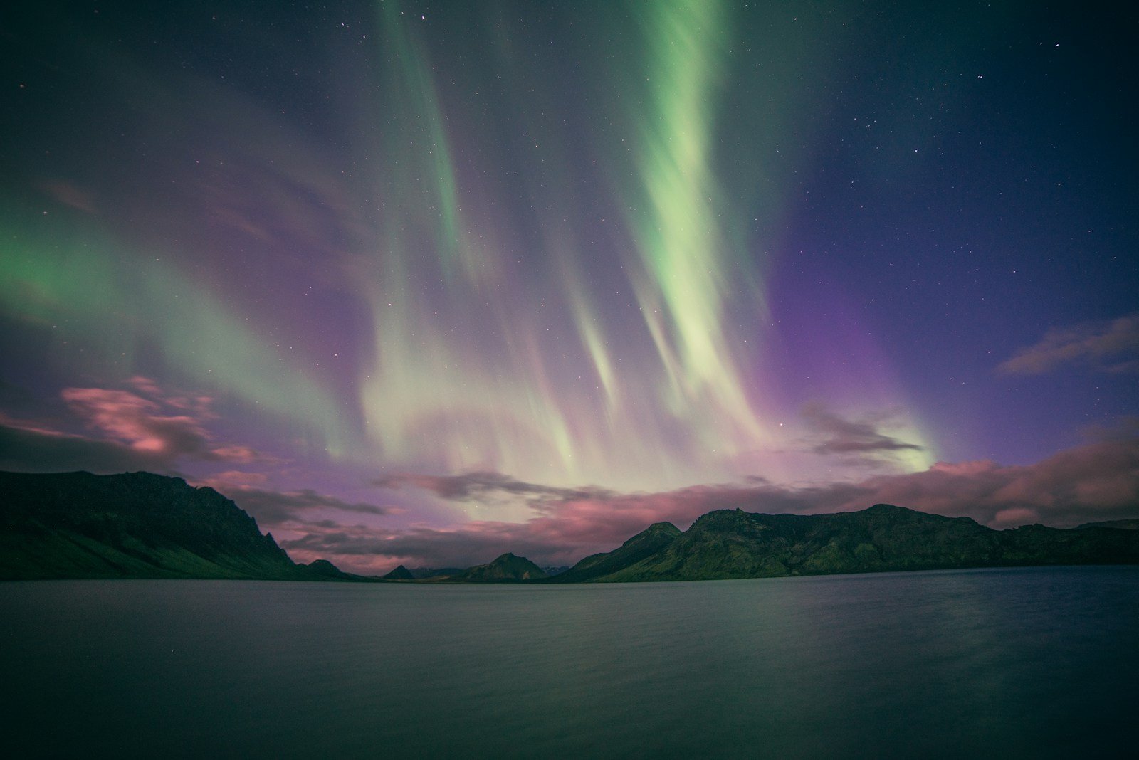 Northern lights over mountains at Álftavatn, Iceland