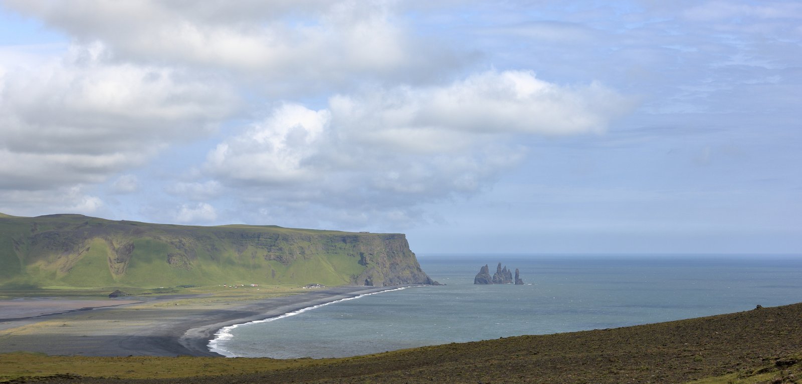 Reynisfjara black sand beach with sea stacks near Vík, Iceland