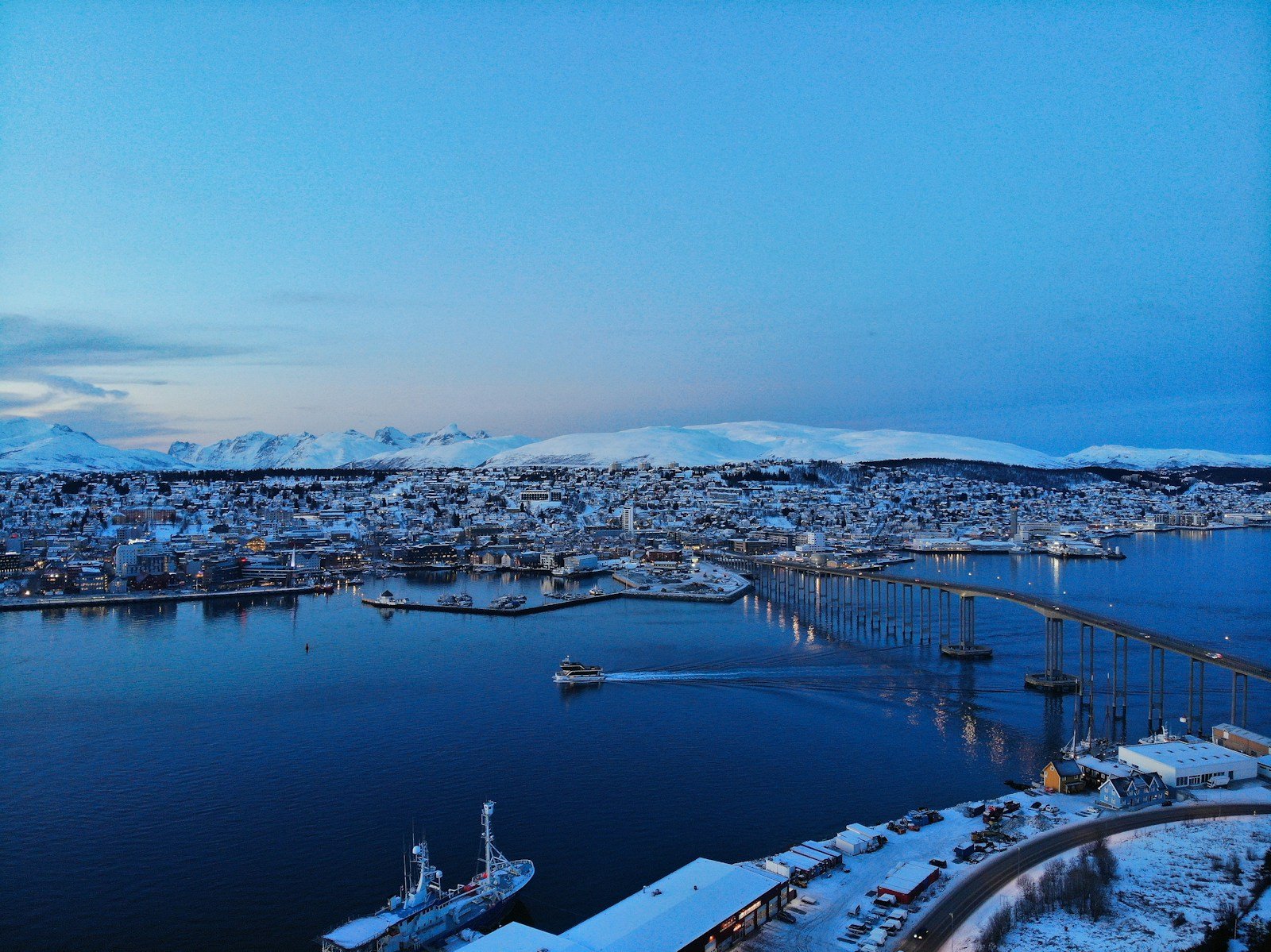 Aerial view of Tromsø, Norway, surrounded by snow-covered mountains and fjords