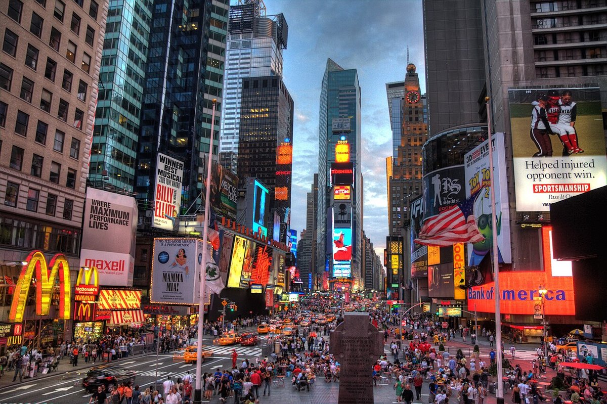 Times Square at night with illuminated billboards and crowded streets