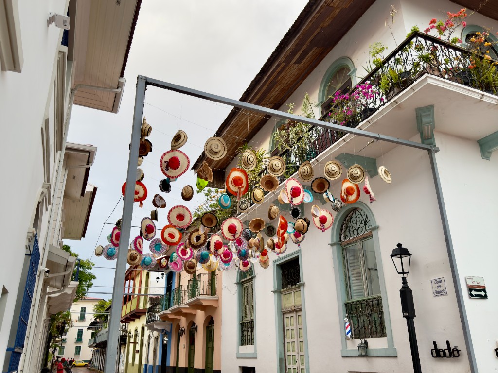 Historic Casco Viejo street in Panama City with colorful hats and colonial balconies