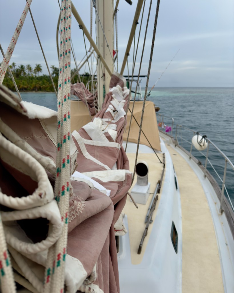 Sailboat deck view in San Blas with tropical shoreline and calm Caribbean water