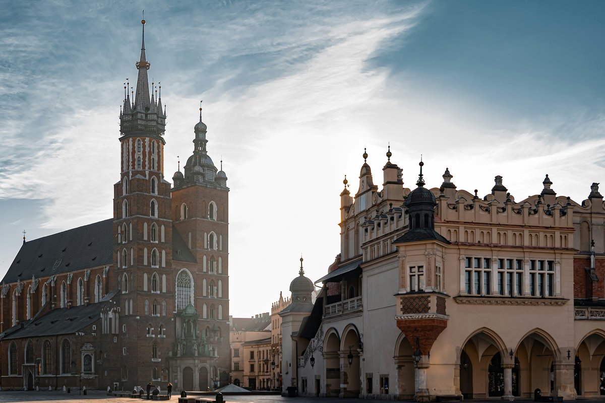St. Mary's Basilica with its two brick towers beside the Renaissance Cloth Hall on Kraków's Main Market Square