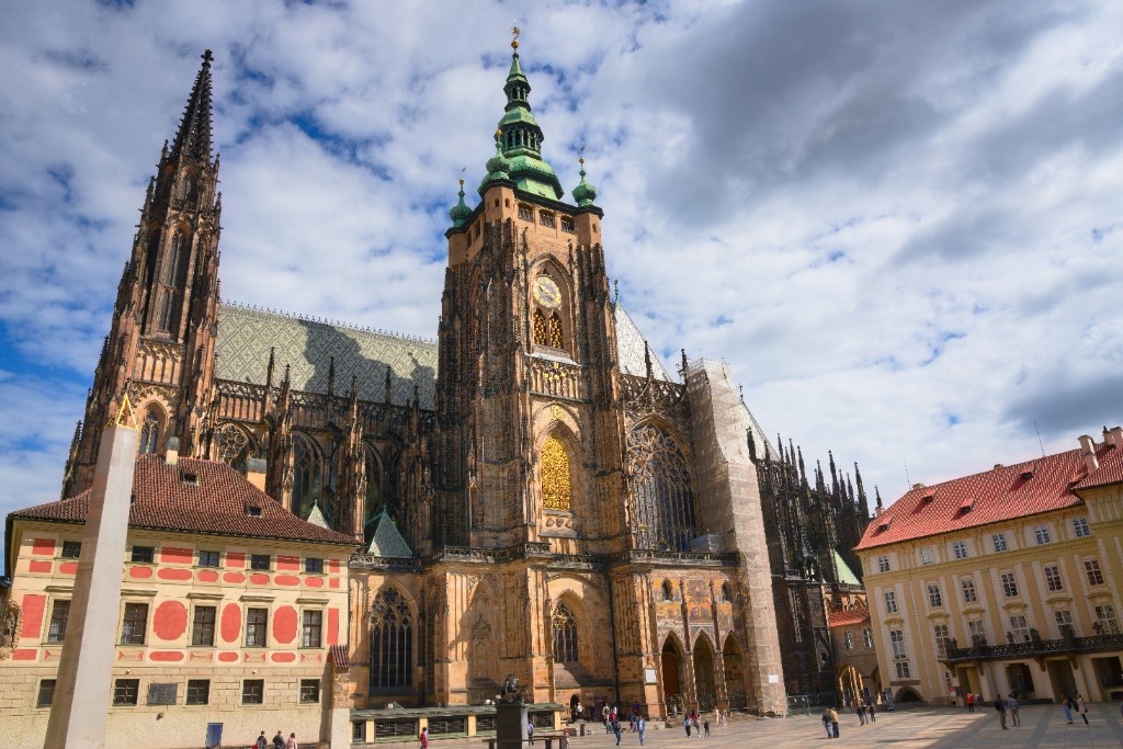 St. Vitus Cathedral in Prague Castle’s Third Courtyard under a cloudy blue sky