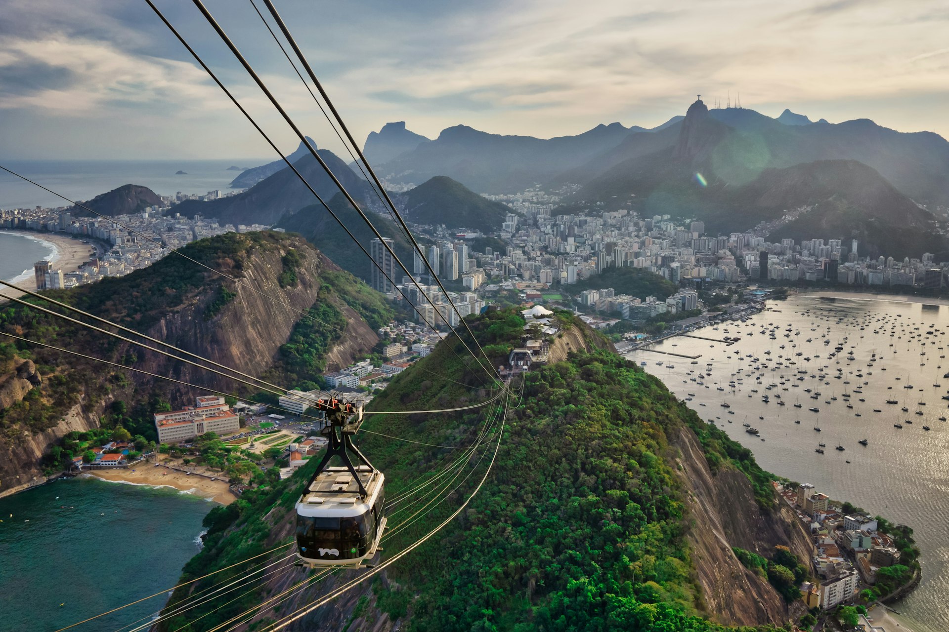 Cable cars ascending Sugarloaf Mountain with Rio de Janeiro coastline in the background