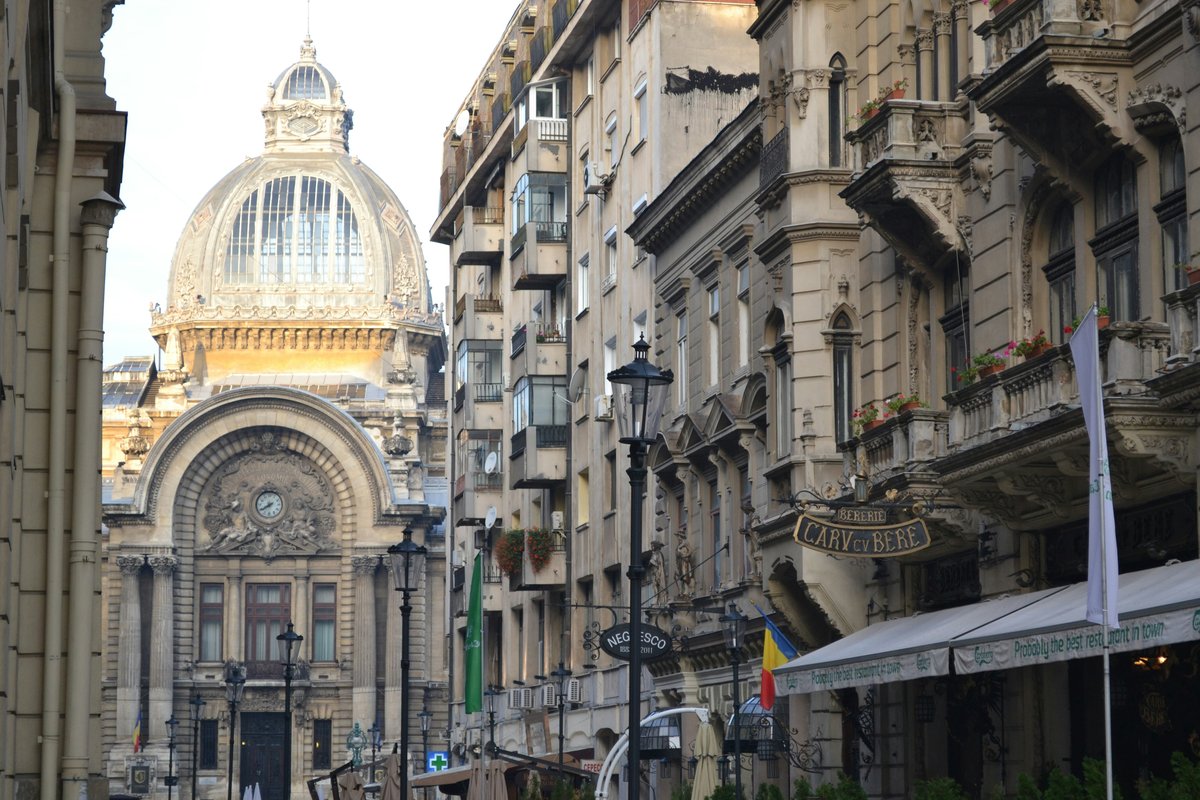 Calea Victoriei in Bucharest, lined with ornate historic buildings and ending at the glass-domed CEC Palace