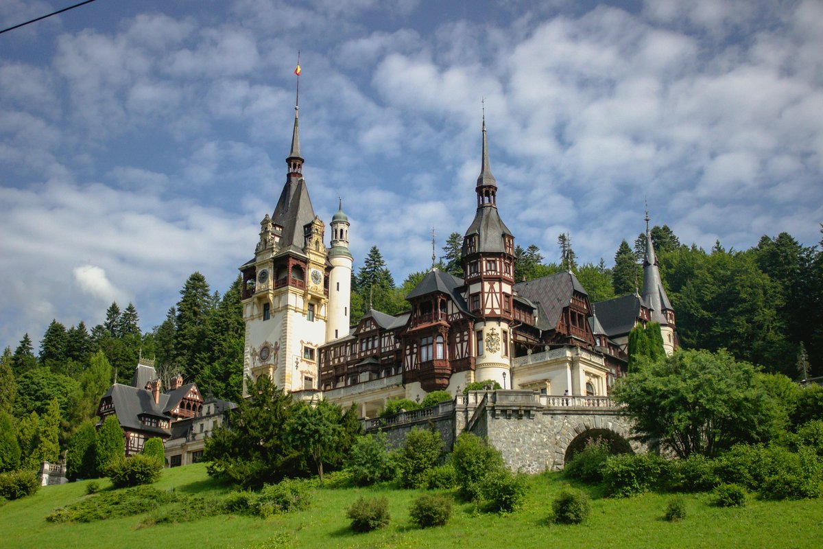Peleș Castle in Sinaia with its pointed towers and timber-framed façades set against forested hills