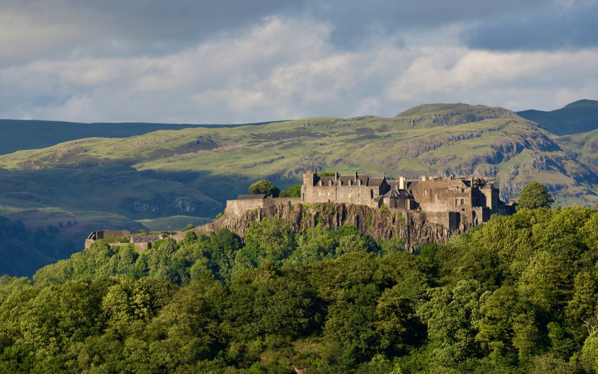 Stirling Castle perched on Castle Hill above forests and central Scotland hills