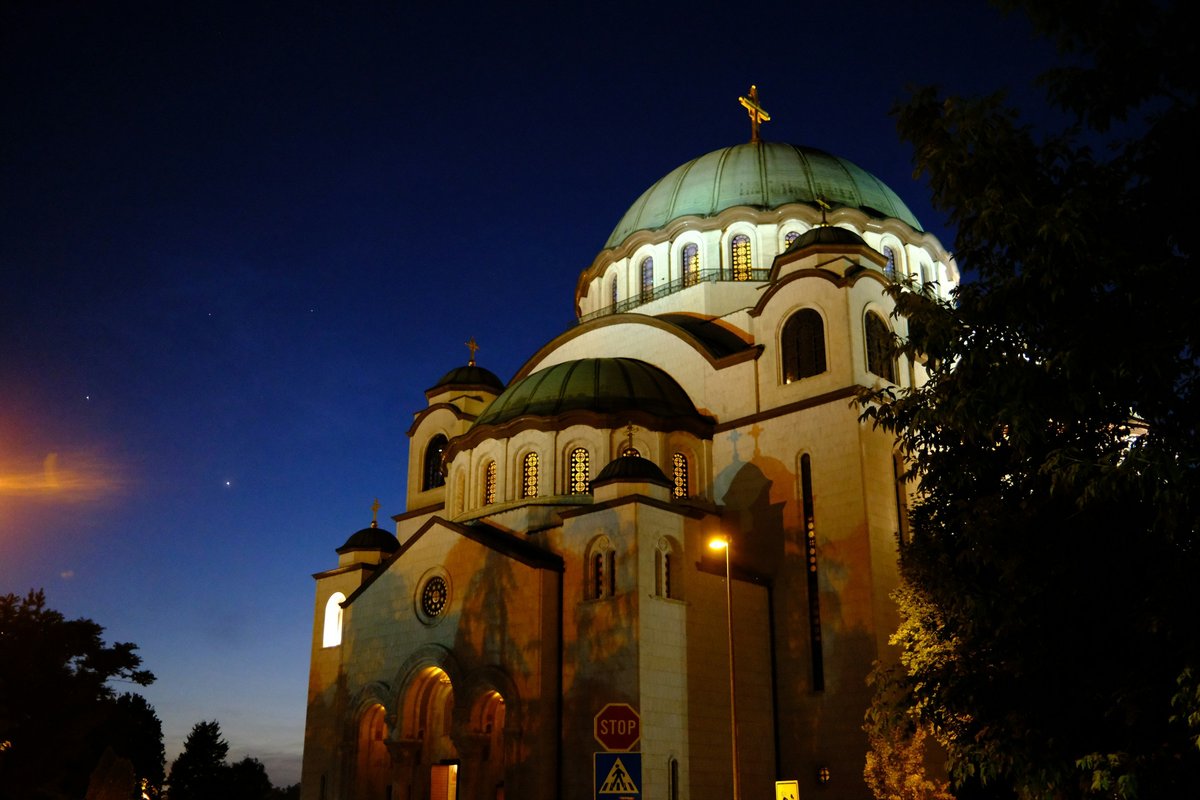 The Church of Saint Sava in Belgrade at night, with its dome illuminated against a dark sky