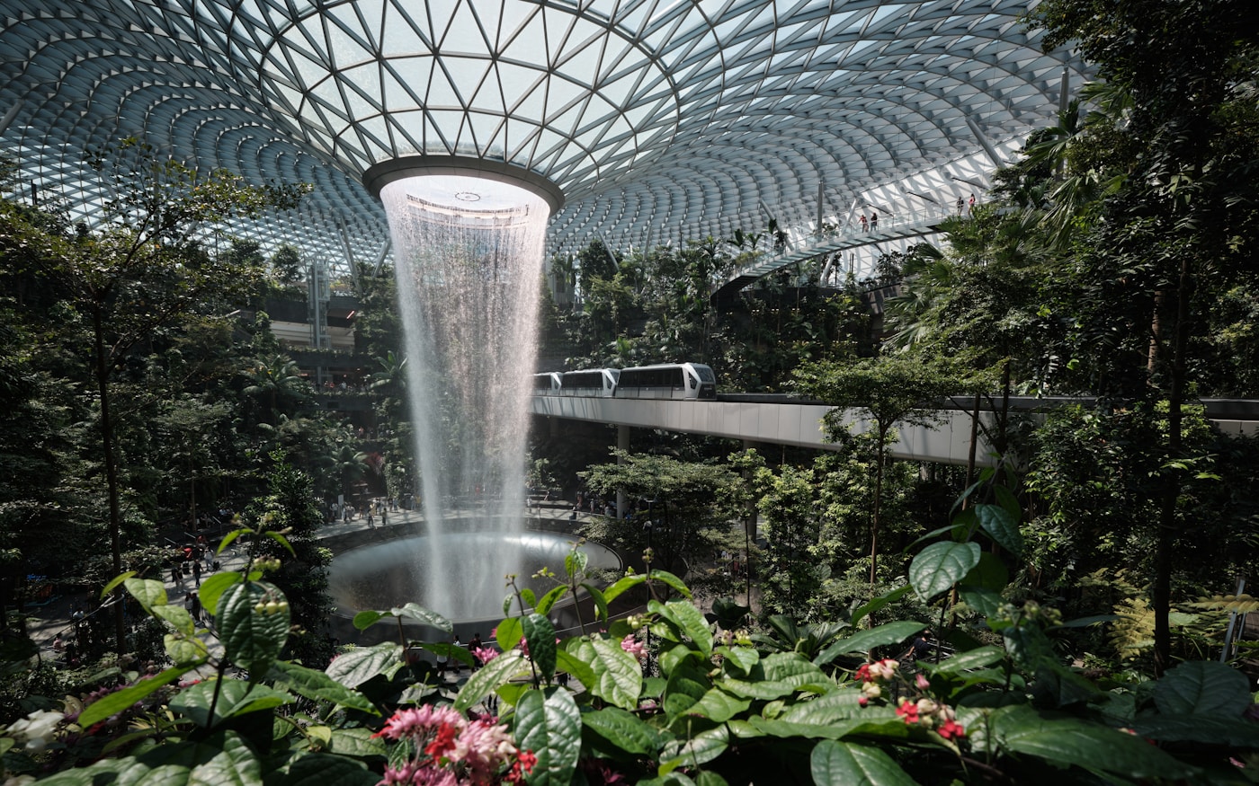 Indoor waterfall at Jewel Changi Airport surrounded by tropical gardens