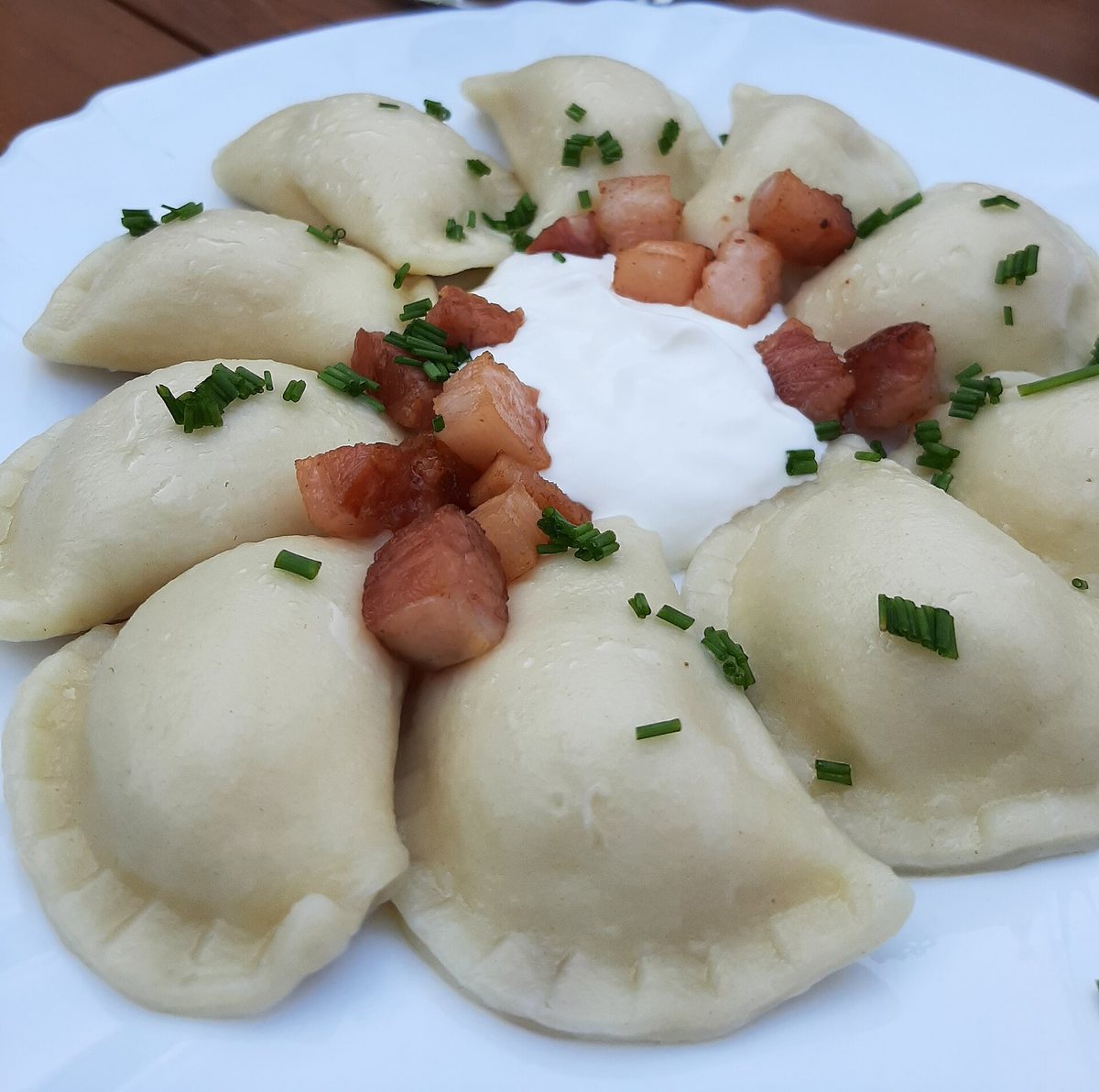 Pirohy served with sour cream, bacon and chives